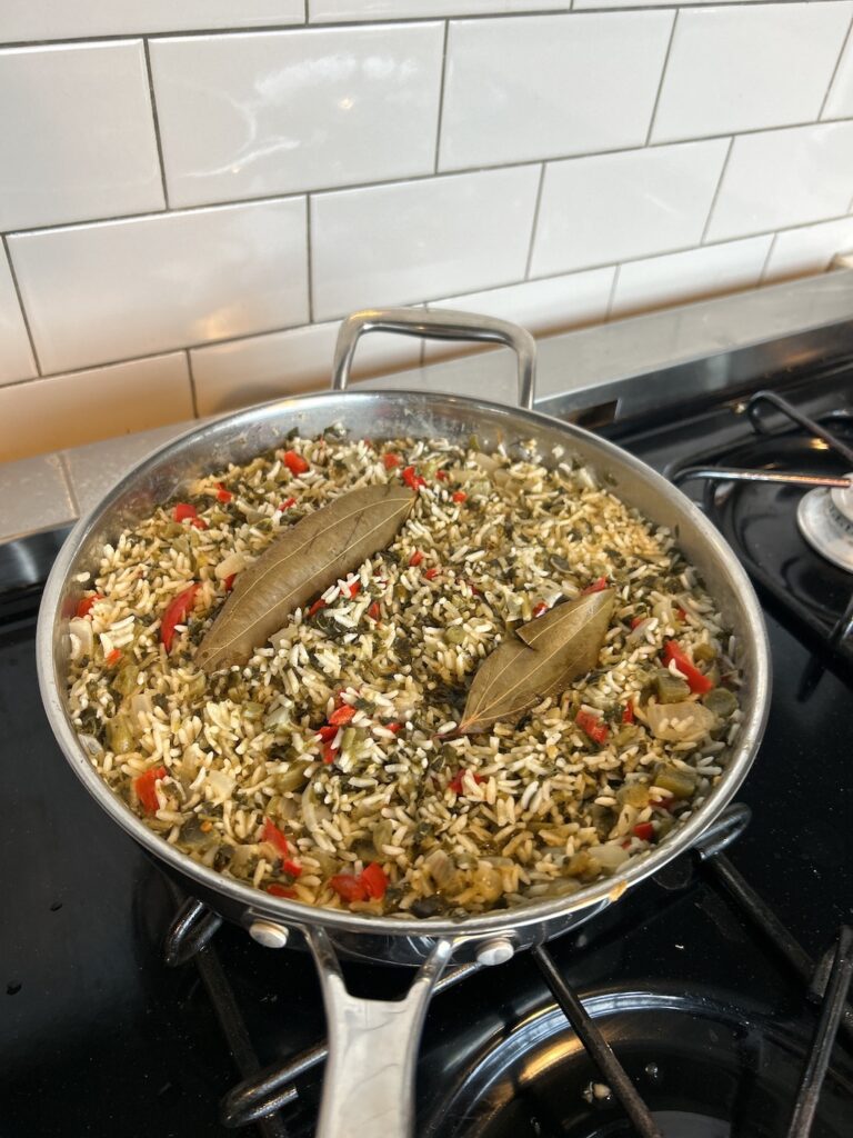 A bowl of flavorful callaloo rice with coconut, a Caribbean-inspired dish