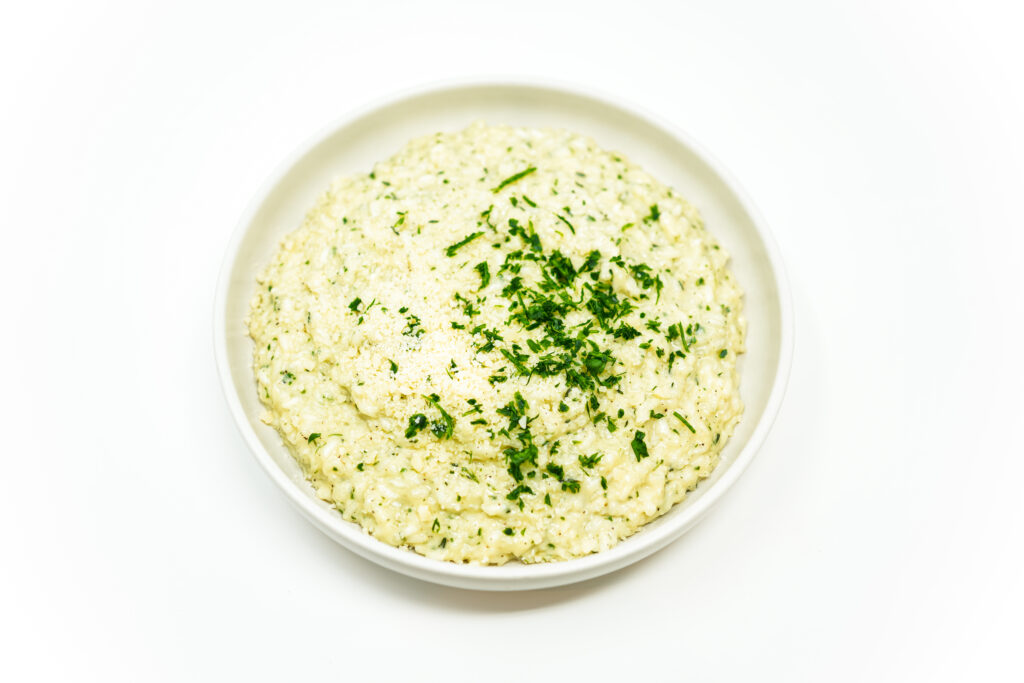 Creamy Parmesan Risotto served in a bowl, featuring tender Arborio rice cooked to perfection in a rich, creamy sauce, infused with savory Parmesan cheese for a velvety and comforting dish