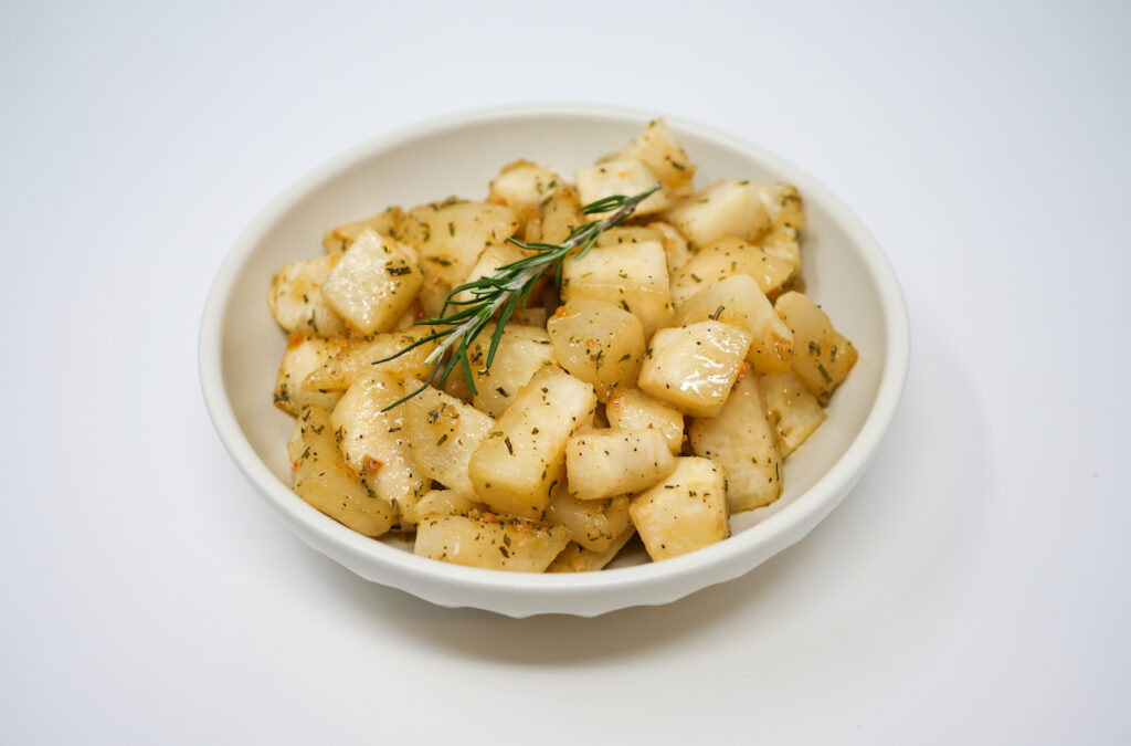 Rosemary glazed turnips served on a plate, featuring tender turnip pieces coated in a savory rosemary-infused glaze, offering a flavorful and aromatic side dish with a perfect balance of sweetness and herbs