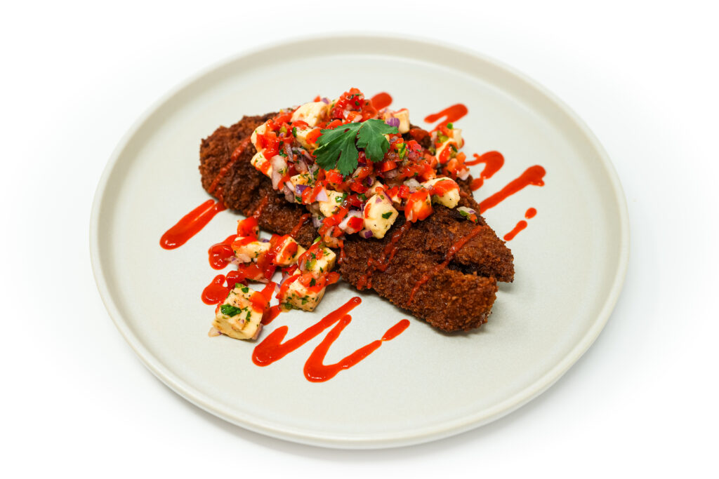 Crispy Coconut Crusted Grouper with Thai Banana Salsa served on a plate, featuring golden, crunchy coconut-crusted grouper paired with a refreshing and sweet Thai banana salsa, offering a tropical and flavorful combination