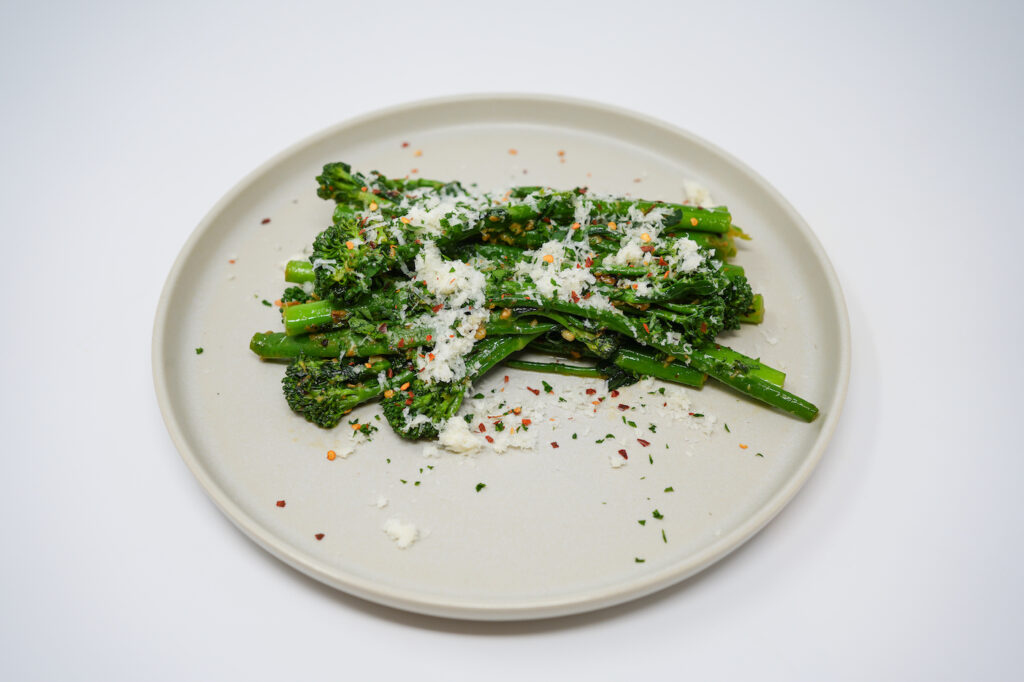 Garlic and Red Pepper Flake Sautéed Broccolini served on a plate, featuring tender broccolini sautéed with fragrant garlic and a hint of heat from red pepper flakes, creating a simple yet flavorful side dish