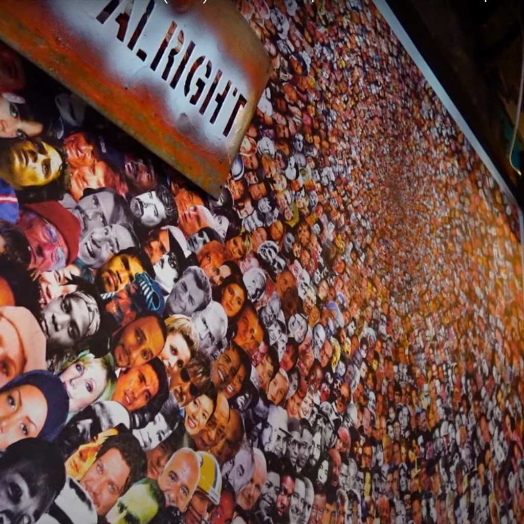 Wall collage of colorful, overlapping celebrity faces inside the eclectic café Forgtmenot.