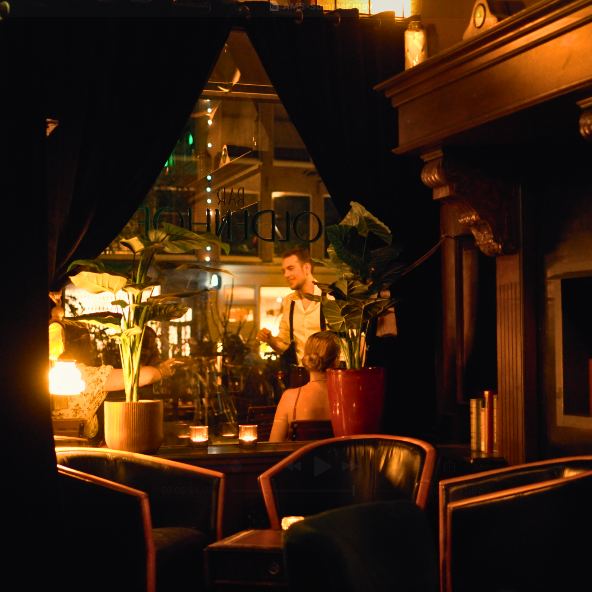 Dimly lit interior of Bar Oldenhof in Amsterdam, a hidden speakeasy-style cocktail bar with vintage charm and craft cocktails.