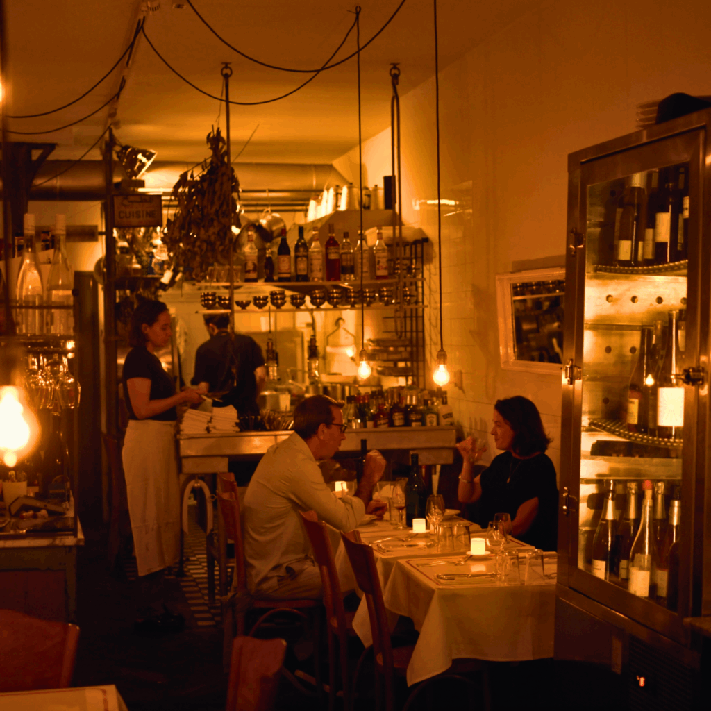 Warm candlelit dining room at Balthazar’s Kitchen, a cozy Amsterdam restaurant known for seasonal menus and intimate atmosphere.