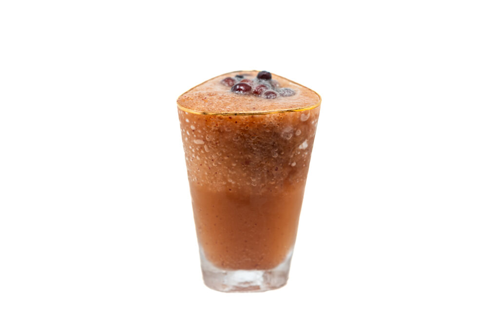 Frozen Thomcord Grape Mule cocktail with frozen grape garnish in a tall glass