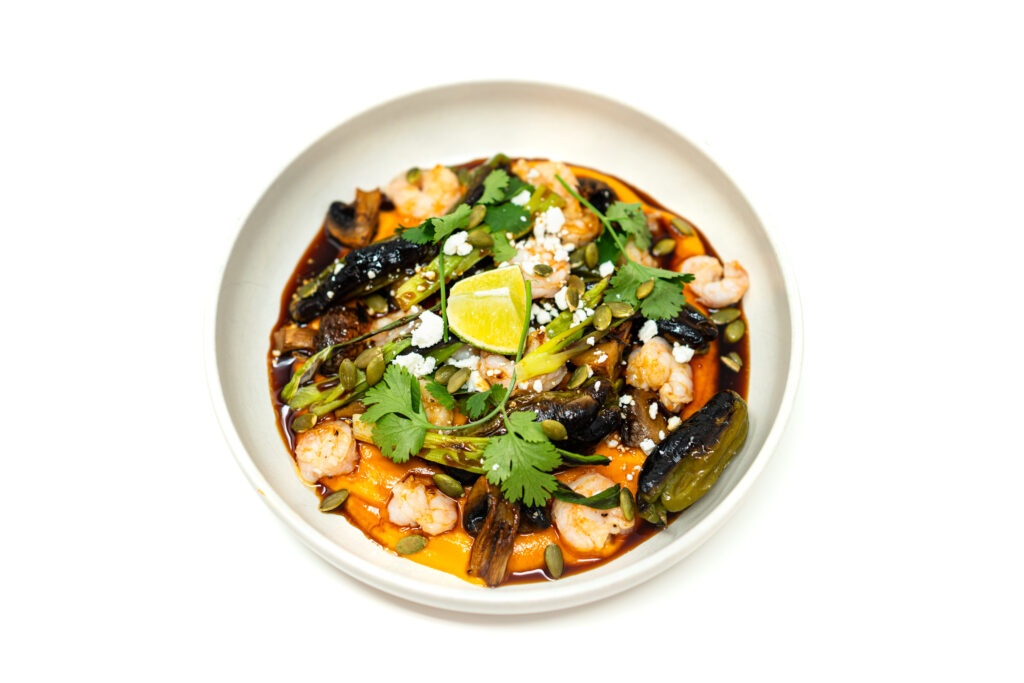 Roasted shrimp, shishito peppers, mushrooms, and sweet potatoes served over a smooth sweet potato purée with yaki sauce and fresh herbs.