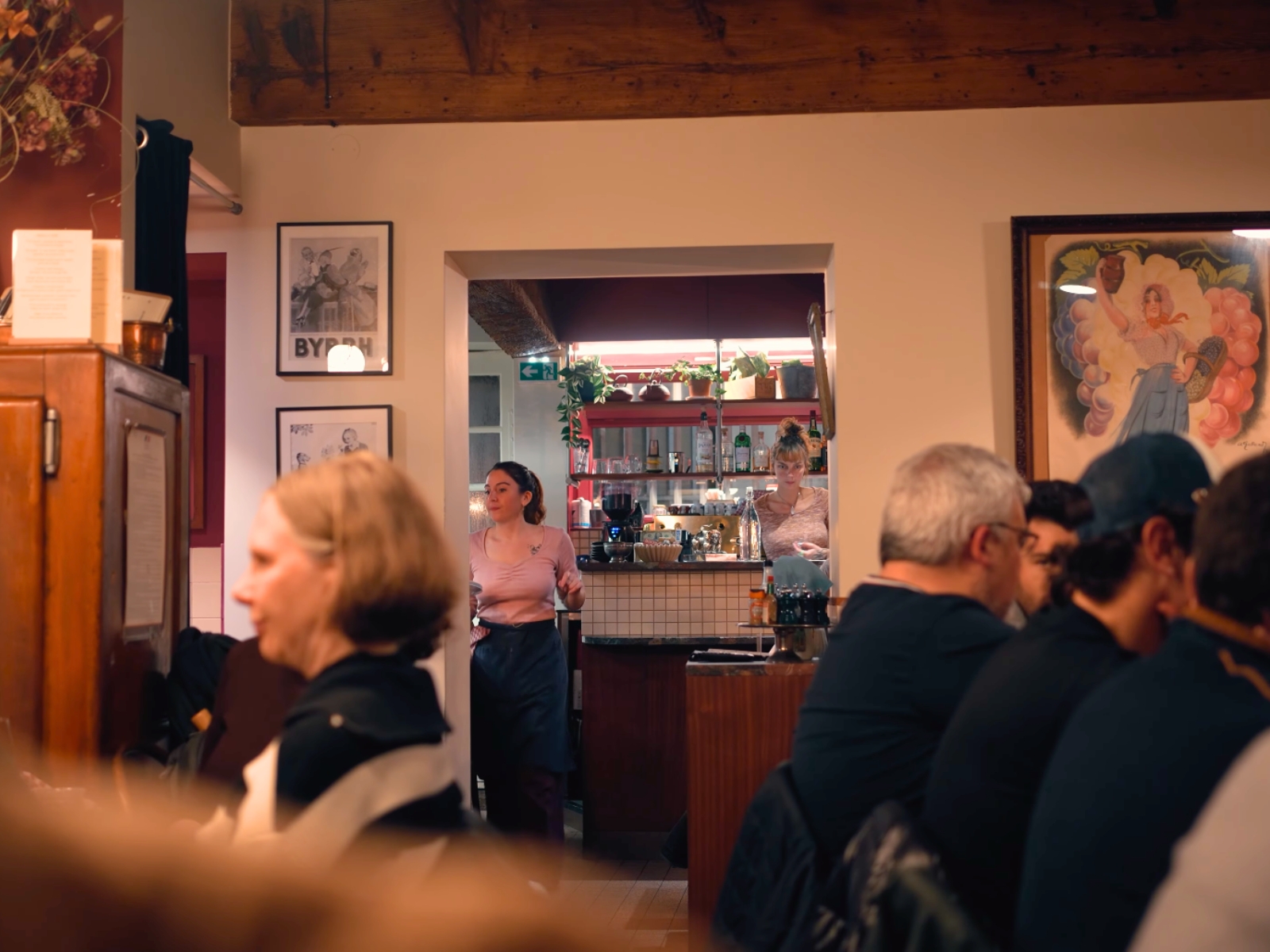 Guests enjoying dinner in the cozy, traditional dining room of Le Bouchon des Filles.