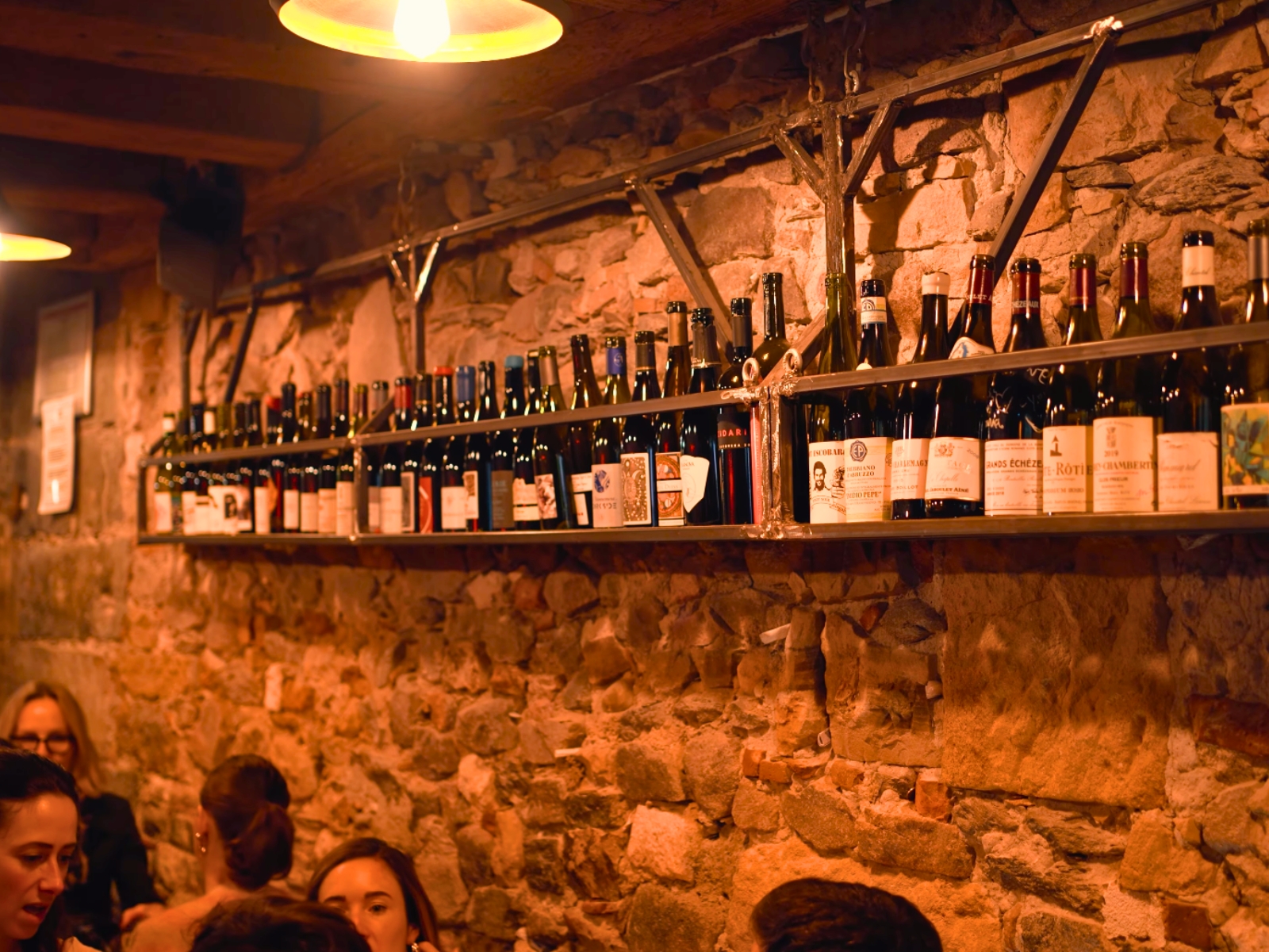 A sprawling wall of natural and regional wines glowing warmly at Armada.