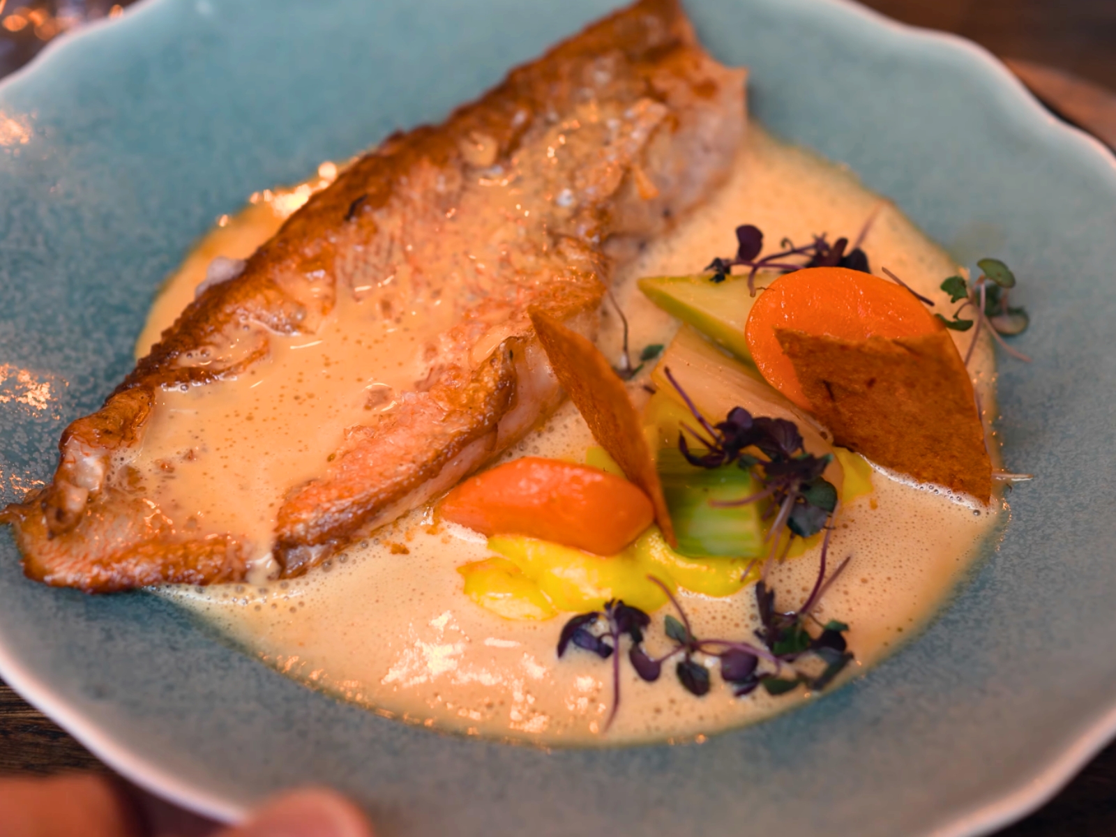 A masterfully roasted fish resting in a vibrant, vegetable-driven emulsion at L'Etabli.
