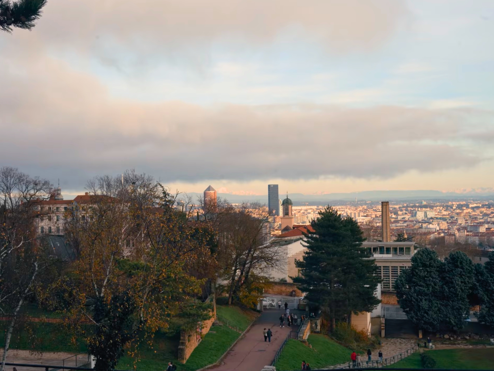 A panoramic view of the Lyon, France city skyline under a cloudy sky.