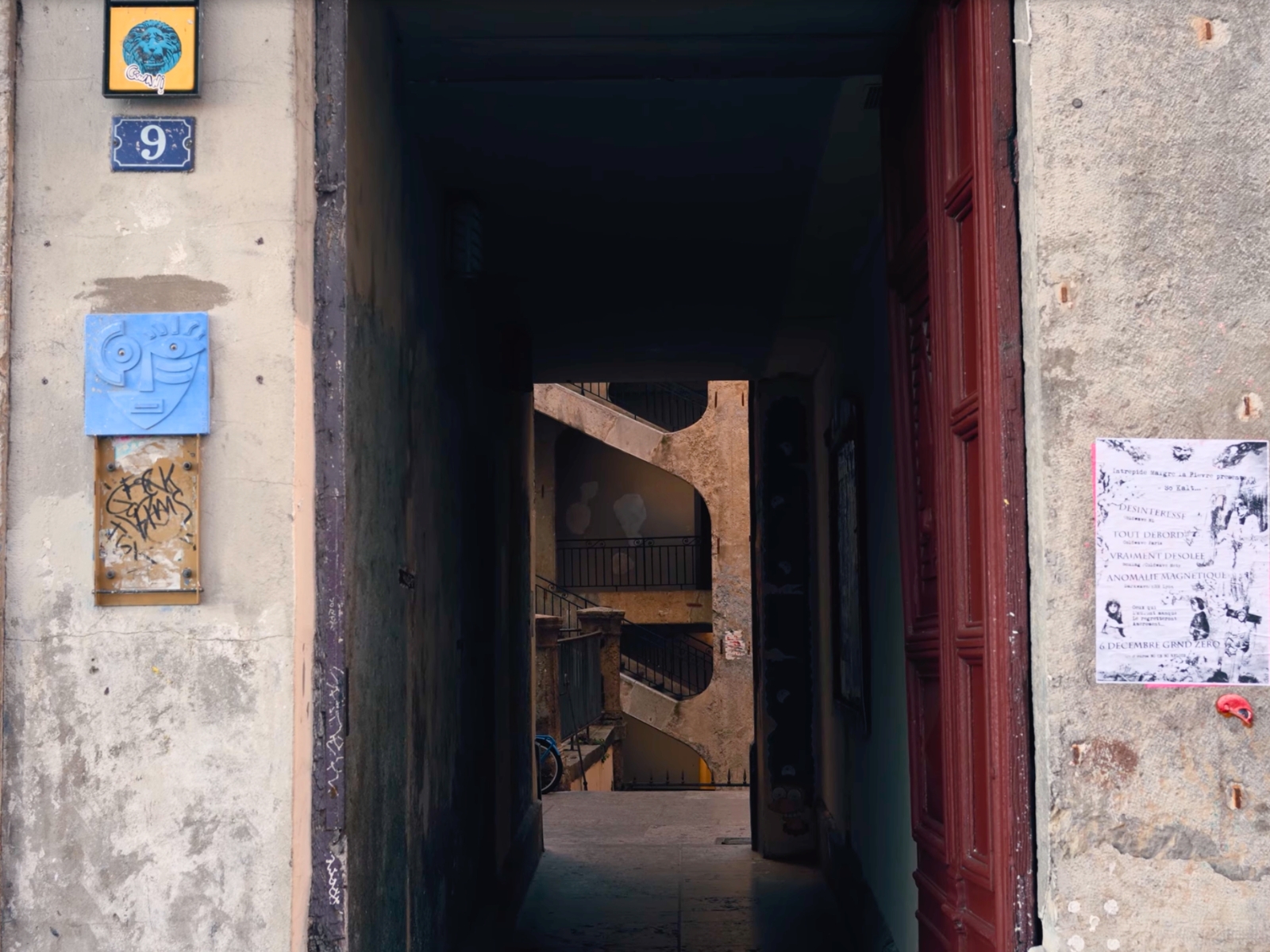 A dark, hidden interior hallway of a historic Lyonnaise traboule.