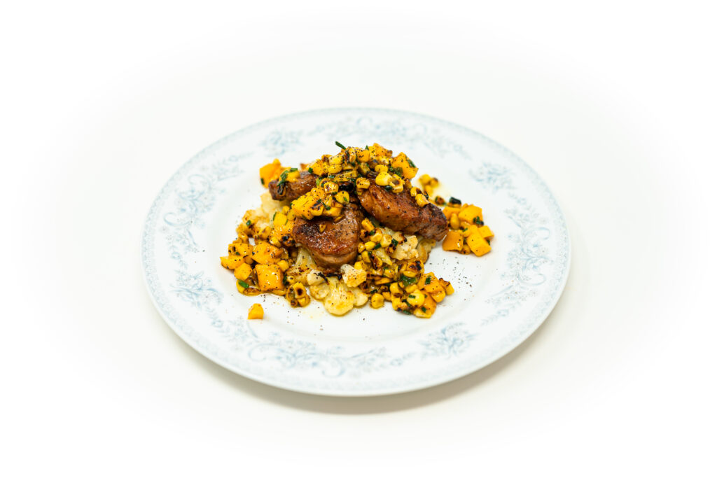 Seared pork medallions over crispy smashed cauliflower topped with charred corn and mango salsa.
