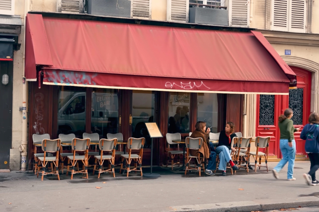 Exterior view of the iconic Clown Bar in Paris featuring its red awning.