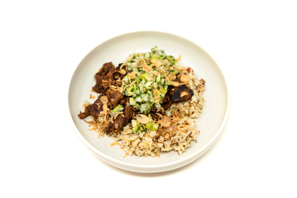 Shaved pork butt glazed in dark soy over crispy cumin rice topped with bright diced green tomato and fried shallots.